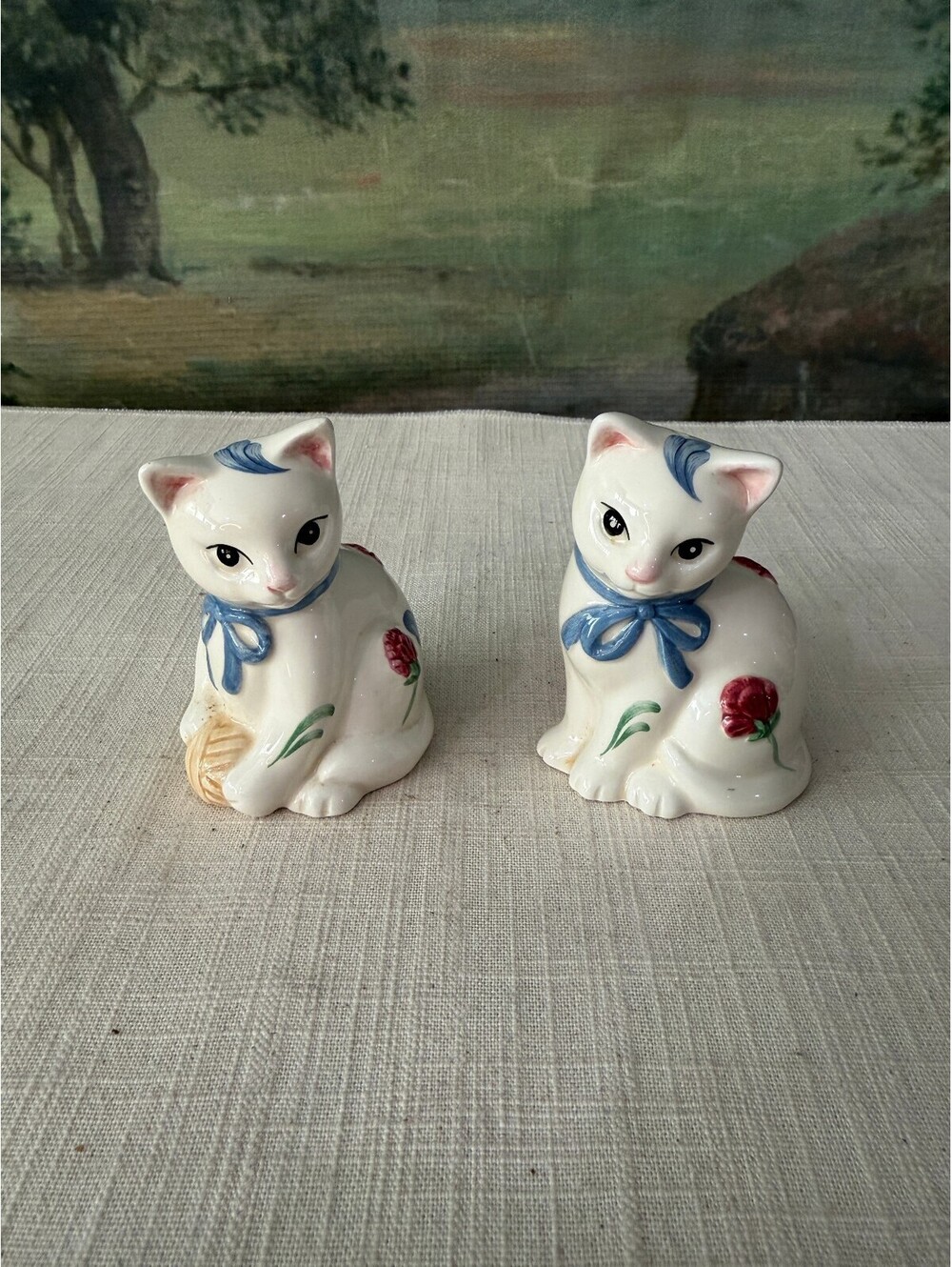 Pair of White Ceramic Cat Figurines with Blue Bows and Red Flowers